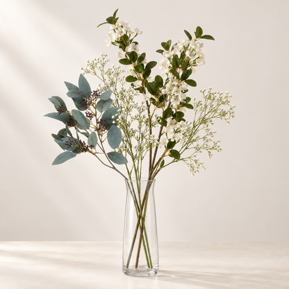 White Meadow artificial flowers styled in a clear glass vase. AI-generated illustration; vase not included.