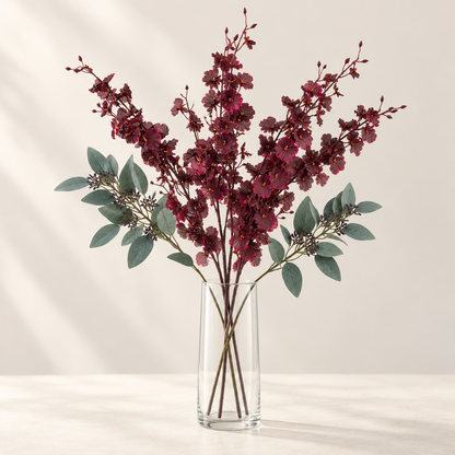 Burgundy Orchid artificial flowers styled in a clear glass vase. AI-generated illustration; vase not included.