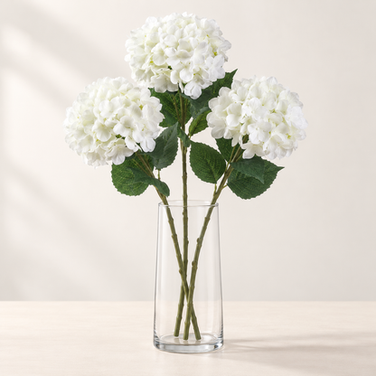 White Hydrangea (3 stems) artificial flowers in a clear glass vase. AI-generated styling illustration; vase not included.