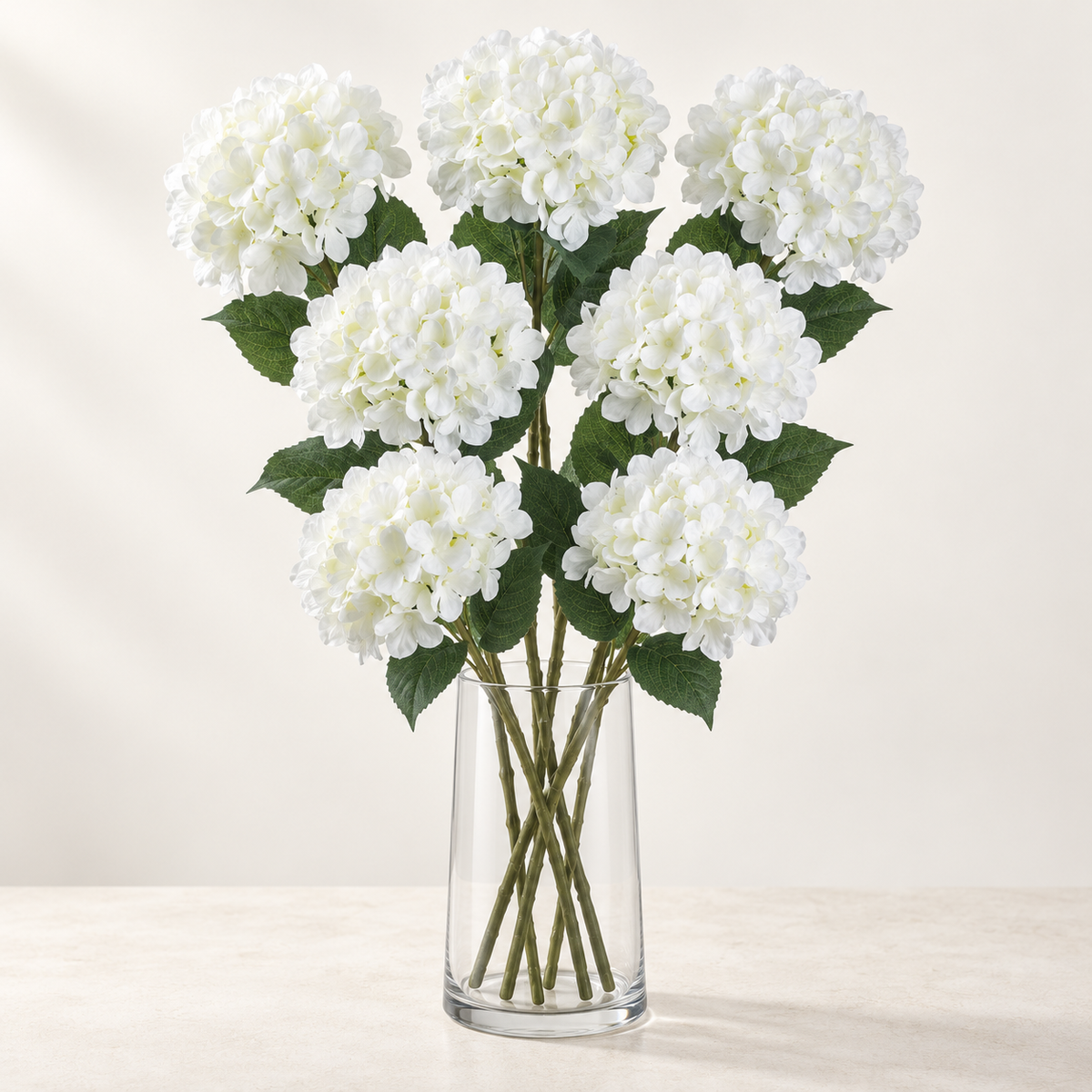 White Hydrangea (7 stems) artificial flowers in a clear glass vase. AI-generated styling illustration; vase not included.